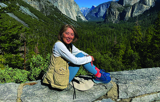 Anne Iwata relaxing in front of a beautiful mountain view